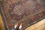 Vintage Qashqai carpet's triple medallion with pomegranate trees and colorful field motifs.