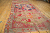 Hand-knotted texture of antique Caucasian runner with brilliant green, cochineal red, and tattered fringe.
