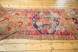 Hard tattered end of antique Caucasian runner, revealing a geometric checkered border.