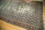 Antique Malayer runner, navy field with repeating boteh pattern, brick red border, visible wear.