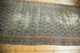 Antique Malayer runner, allover boteh motif in navy, brick red, gold, and visible wear.