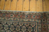 Antique Malayer rug runner border, intricate brick red and navy floral motifs, visible wear.