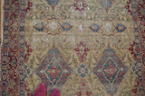 Threadbare pile revealing the ivory foundation and intricate motifs of a collector Kermanshah rug.