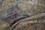 Storied wear and threadbare texture on a folded antique Persian Kermanshah with intricate details.