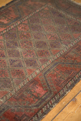 Belouch rug's wide border with meandering vine, lattice field, showing even wear to foundation.