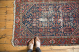 Detailed view of foundation showing through the Herati motif on a vintage navy Persian rug.