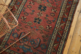 Antique Lilihan rug's dusty raspberry field, with sky blue and ivory floral motifs and detailed border.