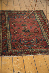 Intricate wine red and sky blue patterns on the hand-knotted antique Lilihan rug.