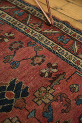 Antique Persian Lilihan rug detail shows intricate red and blue floral motifs with mostly even wear and white knots.