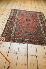 Antique Persian Lilihan rug's lower border, with red, blue patterns, and potted plant motif.
