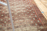 Antique Belouch rug detail: Exposed foundation, terra cotta, charcoal, ivory lattice.