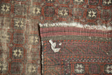 Antique Belouch rug reverse showing woven foundation, hard tatter, and repeating pattern detail.