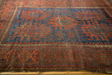 Antique Timuri Belouch rug with visible indigo blue serrated palmettes and even wear.
