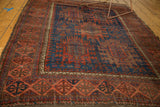 Antique Timuri Belouch rug's geometric border patterns in terra cotta red and deep indigo blue.