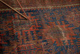Antique Timuri Belouch rug's visible knot heads in indigo, terra cotta, and brown patterns.