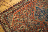 Mahal rug detail: serrated medallion edge, henna plant motifs, and faded terra cotta.