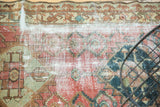 Antique Malayer rug detail, worn gem blush and green patterns with visible foundation.
