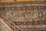 Close-up of antique Mahal carpet's intricate Mustafi design, featuring terra cotta, blue, and ivory hues.