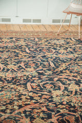 Aged indigo blue and peach floral Mustafi pattern of an antique Persian Mahal carpet.