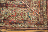 Antique Mahal carpet detail: intricate Mustafi design, floral patterns, miniature bird, terra cotta, and ivory hues.
