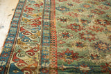 Vibrant geometric border and storied copper green field of an early Caucasian collector rug.