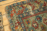 Detail of the tattered edge and storied wear on a rare antique Caucasian rug.