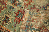 A corner view of a Caucasian collector rug revealing its woven foundation and storied repairs.