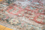 Vintage Mahal carpet with faded cinnabar red and ivory floral bouquets, revealing even wear and foundation.