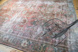 Faded allover oversize floral bouquet pattern on a vintage Mahal carpet with even wear, foundation visible.