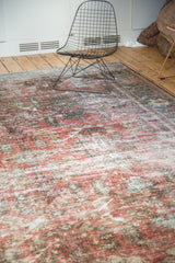 Time-softened dusty rose, cinnabar, and charcoal pile with even wear on a vintage Mahal carpet.