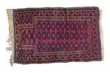 Vintage Belouch rug with a violet purple field and navy serrated gul prayer motif.