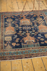 Antique Afshar rug detail showing dark indigo, terra cotta, and sky blue geometric border with low pile.