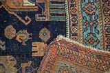Antique Afshar rug's dark indigo field with wear down to knot heads, terra cotta geometric border.