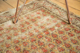 Vintage Mir Arak rug's germinating flower pattern in saffron and terra cotta with even wear.