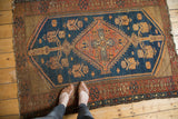 Vintage Kurdish Malayer rug detail: indigo field, rust serrated medallion, and intricate geometric border.