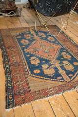 Detail of vintage Kurdish Malayer rug: indigo field, pale rust cyprus tree, and worn border.