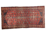 Vintage Malayer runner, cherry red field, allover semi-Herati design, indigo border, visible wear.