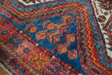 Thick pile on vintage Afshar rug with sky blue, brick red, and tangerine geometric patterns.