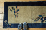 Hand knotted vintage Peking rug runner: navy border, beige field, blush and sky blue tendrils.
