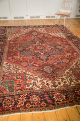 Vintage Heriz rug's navy border with rectilinear geometric patterns, cherry red, ivory.