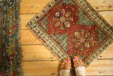 Antique Caucasian square rug features red diamond medallion, blue spandrels, and pinwheel border.