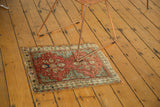 Corner detail of antique Caucasian rug, rich terra cotta, blue geo-floral, and pinwheel border.