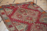 Worn pile of an antique Turkish Yastik rug, featuring serrated hook motifs in red, ivory, and green.