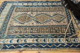Vintage Caucasian rug's detailed border, showcasing geometric cobalt blue, brown, and silver patterns.