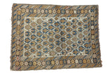 Antique Caucasian rug with floral field and pictorial borders in ivory, sky blue, gold.