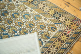 Geometric star and lattice patterns in ivory, sky blue, and saffron on this antique Caucasian rug.