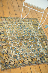 Antique Caucasian rug corner, geometric border of figures, floral motifs, gold, ivory, sky blue.