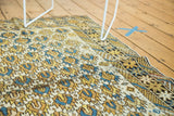 Antique Caucasian rug border featuring stylized human figures, animals, and pinwheel motifs.