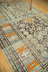Geometric border on antique Caucasian rug with tangerine patterns, even wear, and selvage.