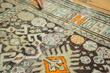 Antique Caucasian rug with geometric floral and ram's horn motifs in aubergine, tangerine.